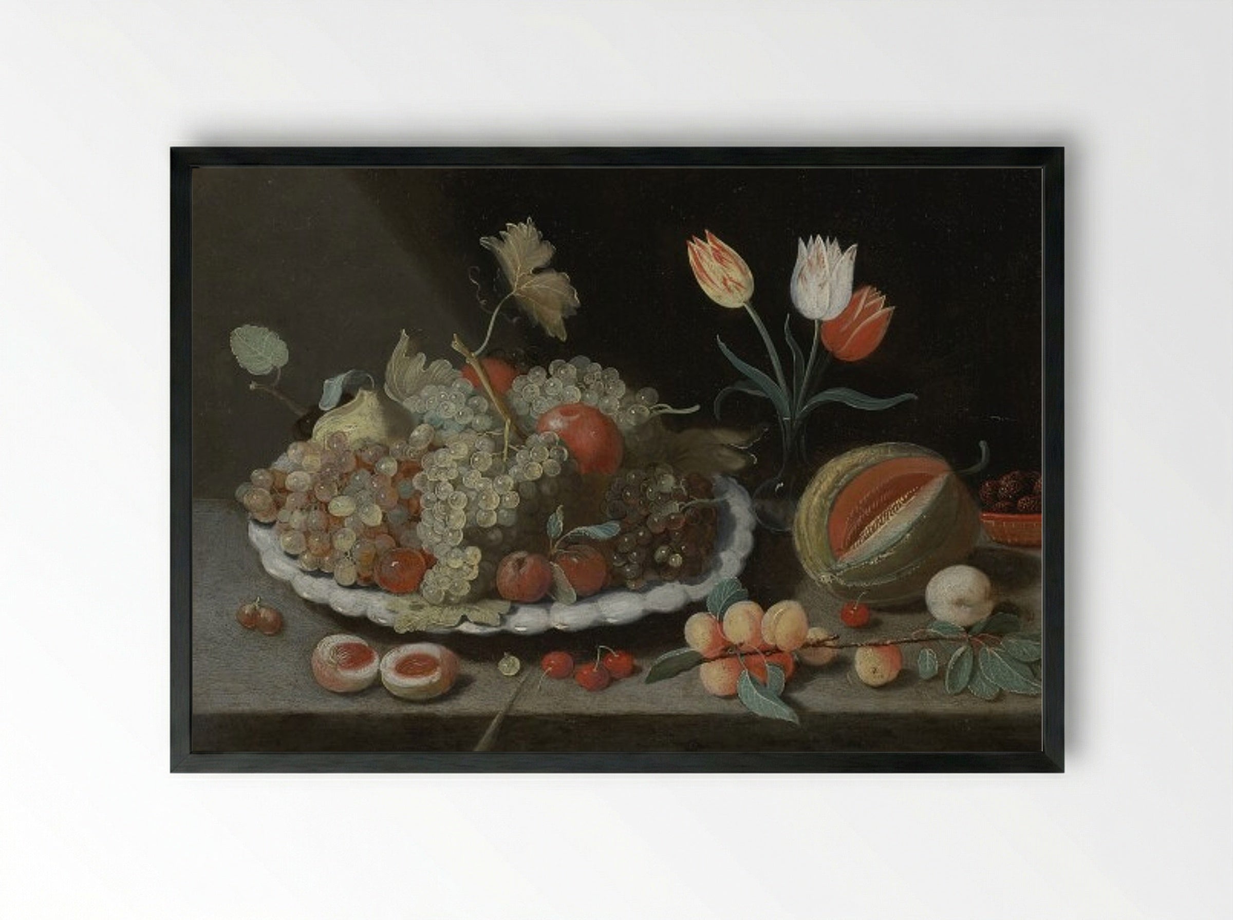 Still life with grapes and other fruit on a platter, a glass vase with tulips, a melon, apricots, cherries and other fruit, all on a ledge - Jan van Kessel the Elder - Framed Print Black