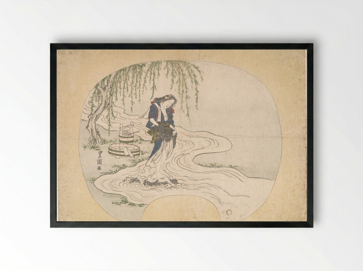 A Woman Stands on a Rock in a Stream Washing Clothes - Utagawa Toyoshige - Framed Print Black