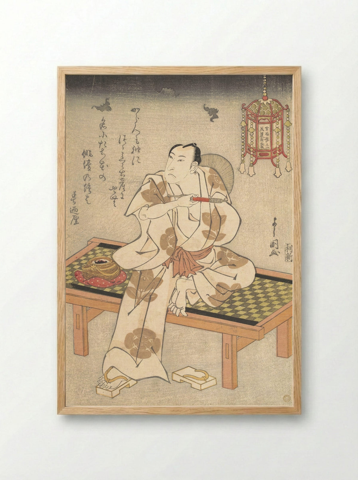 An Actor of the Ichimura Line Sitting on a Shogi (Wooden Bench) and Holding a Pipe - Ippyotei Yoshikuni - Framed Print Wood