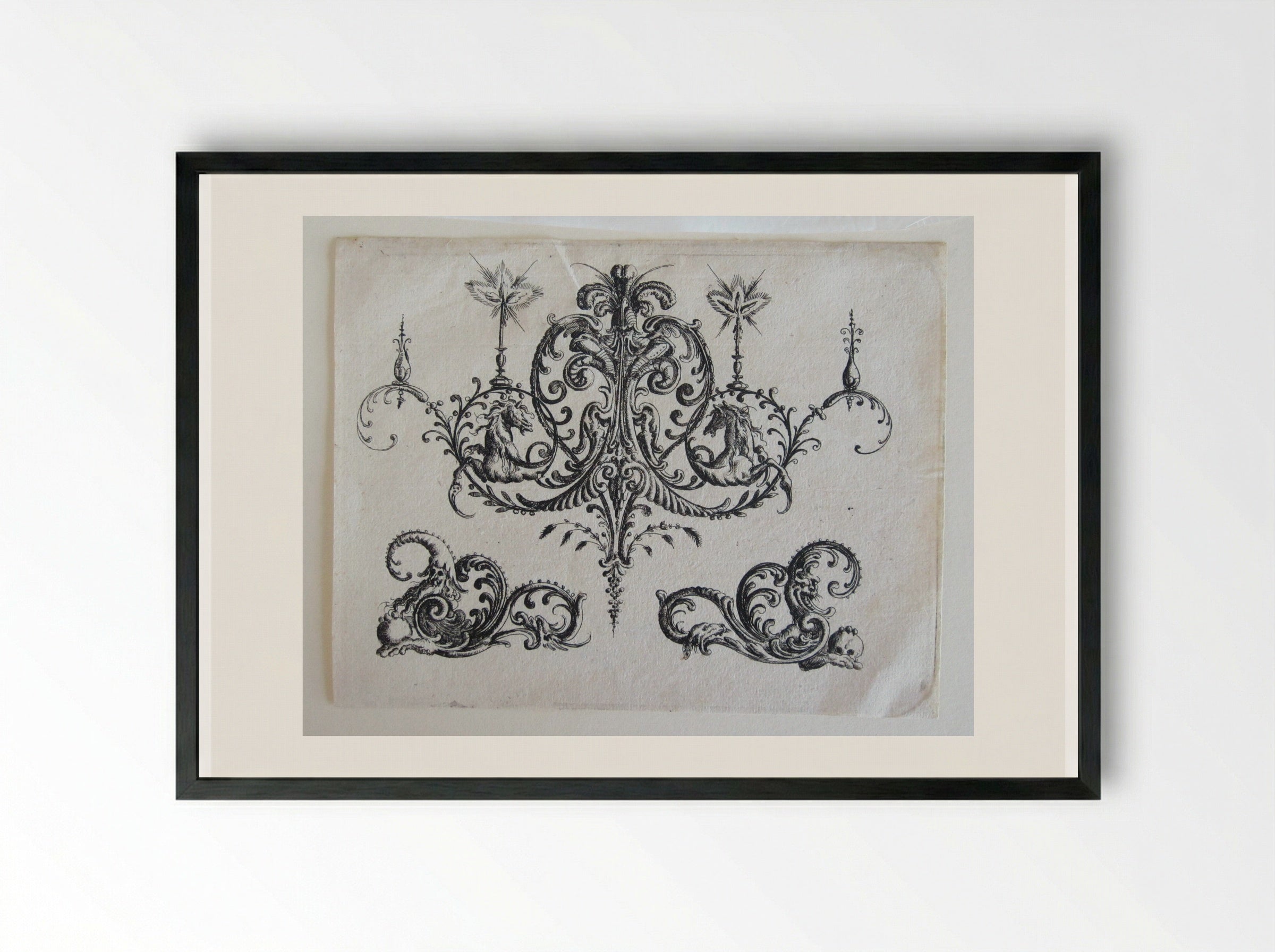 Tripartite Foliate Ornament, the Central Motif with a Helmet, Two Blazing Candles, and Tendrils Ending in Horses - Christoph Jamnitzer - Framed Print Black
