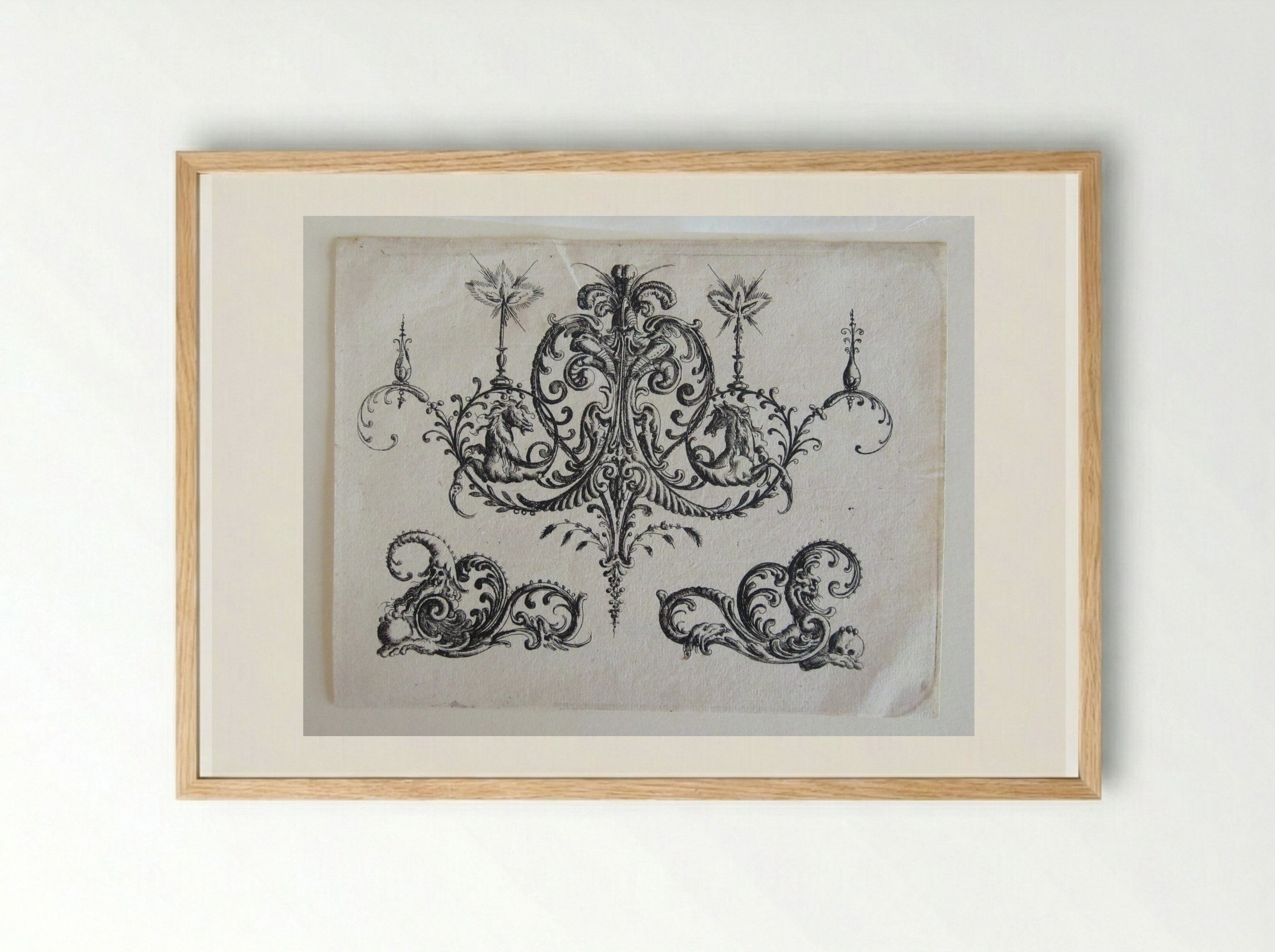 Tripartite Foliate Ornament, the Central Motif with a Helmet, Two Blazing Candles, and Tendrils Ending in Horses - Christoph Jamnitzer - Framed Print Wood