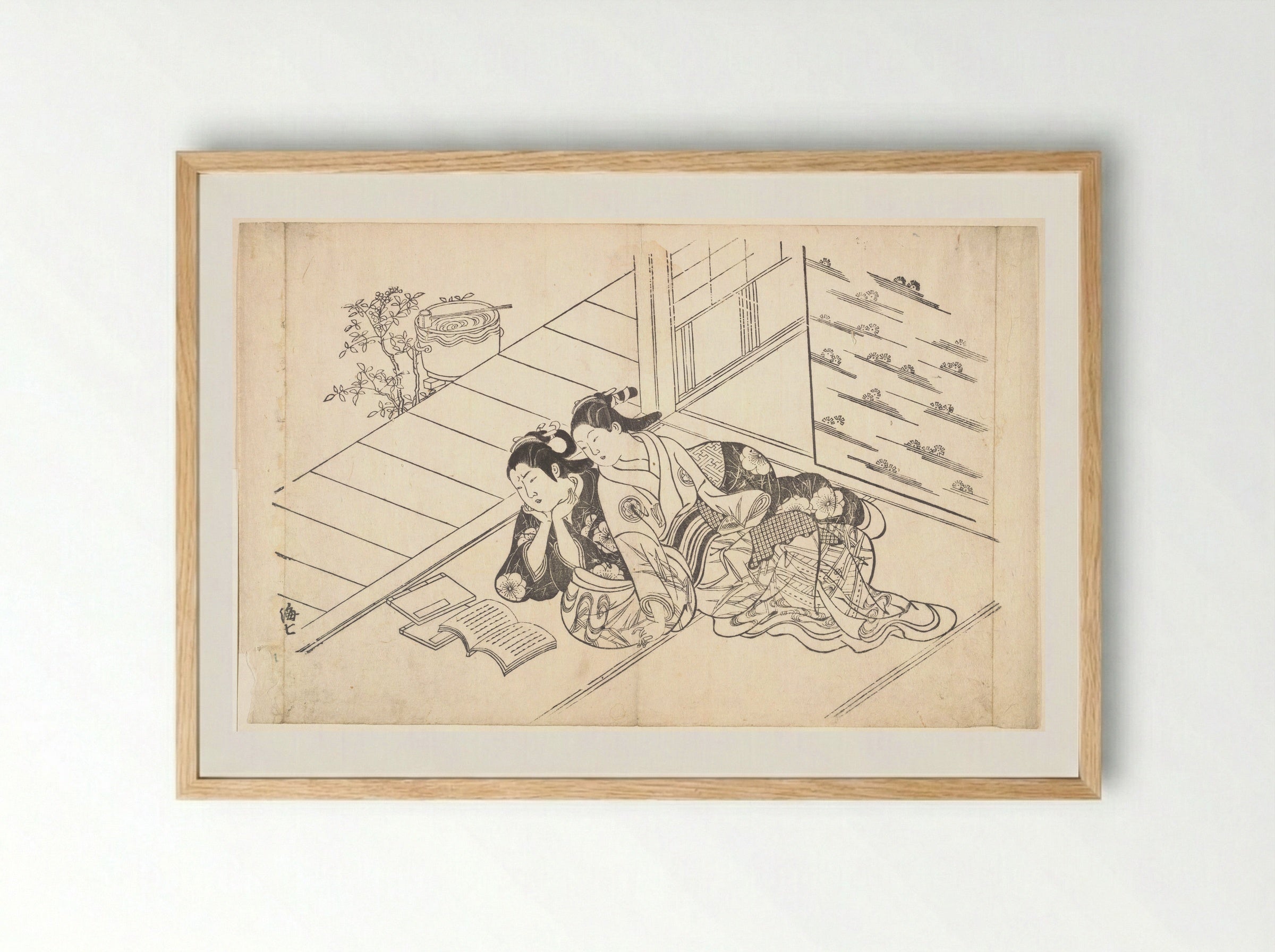 Two Women Reclining on the Floor of a Room and Reading a Book - Nishikawa Sukenobu - Framed Print Wood