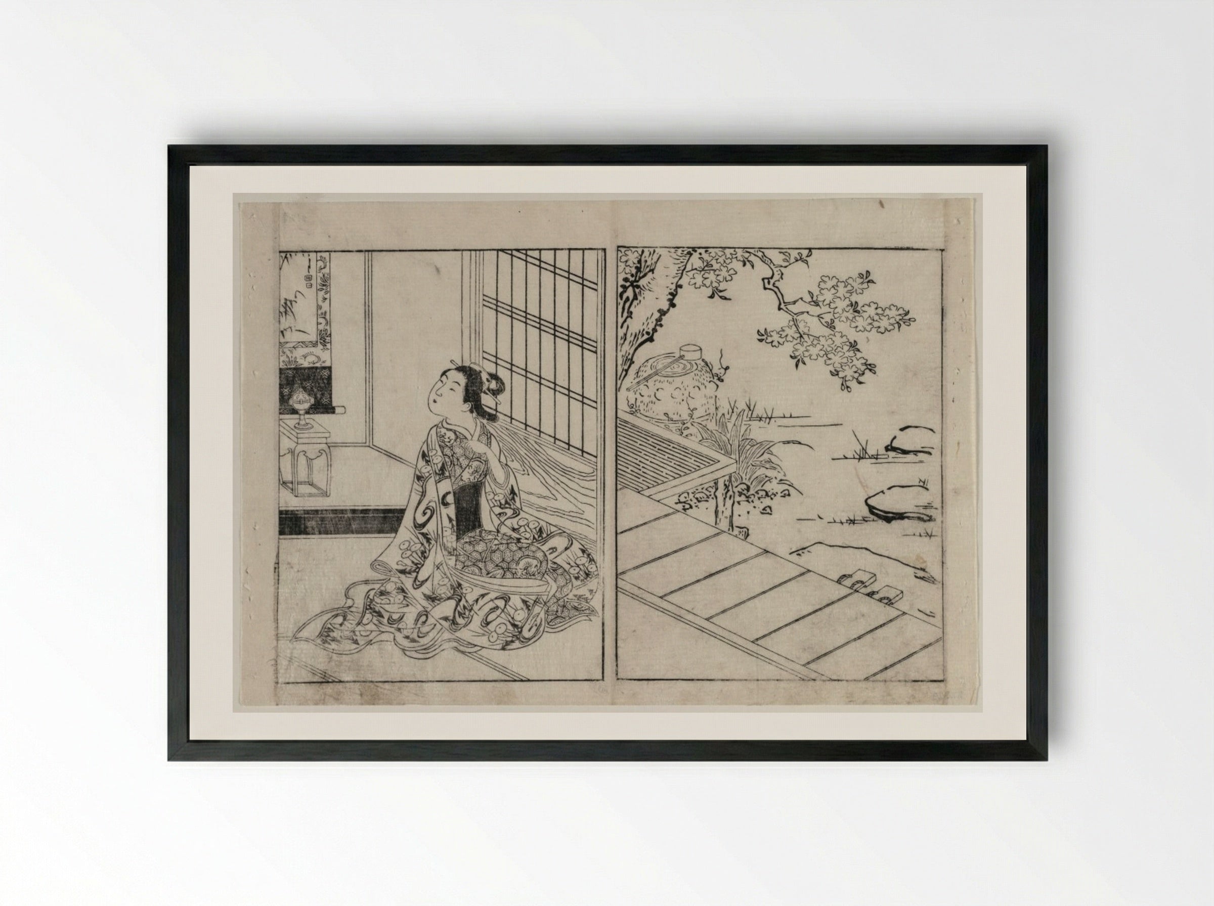 Woman Looking at a Hanging Scroll - Nishikawa Sukenobu - Framed Print Black