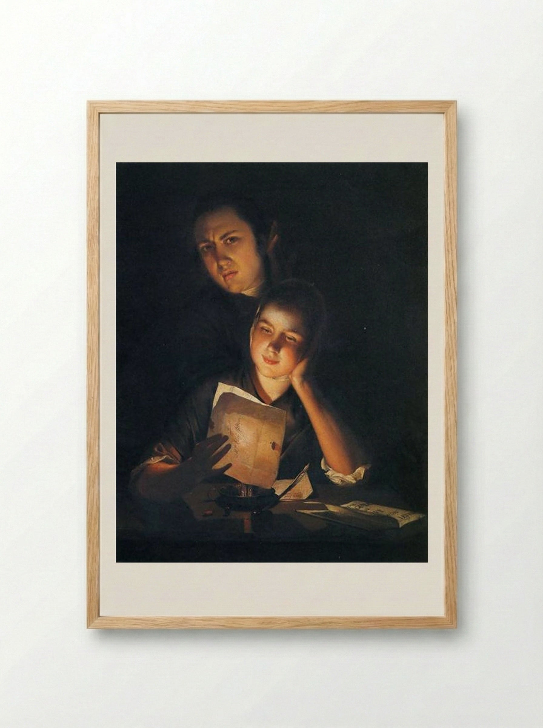 A Girl reading a letter by Candlelight, with a Young Man peering over her shoulder - Joseph Wright - Framed Print Wood