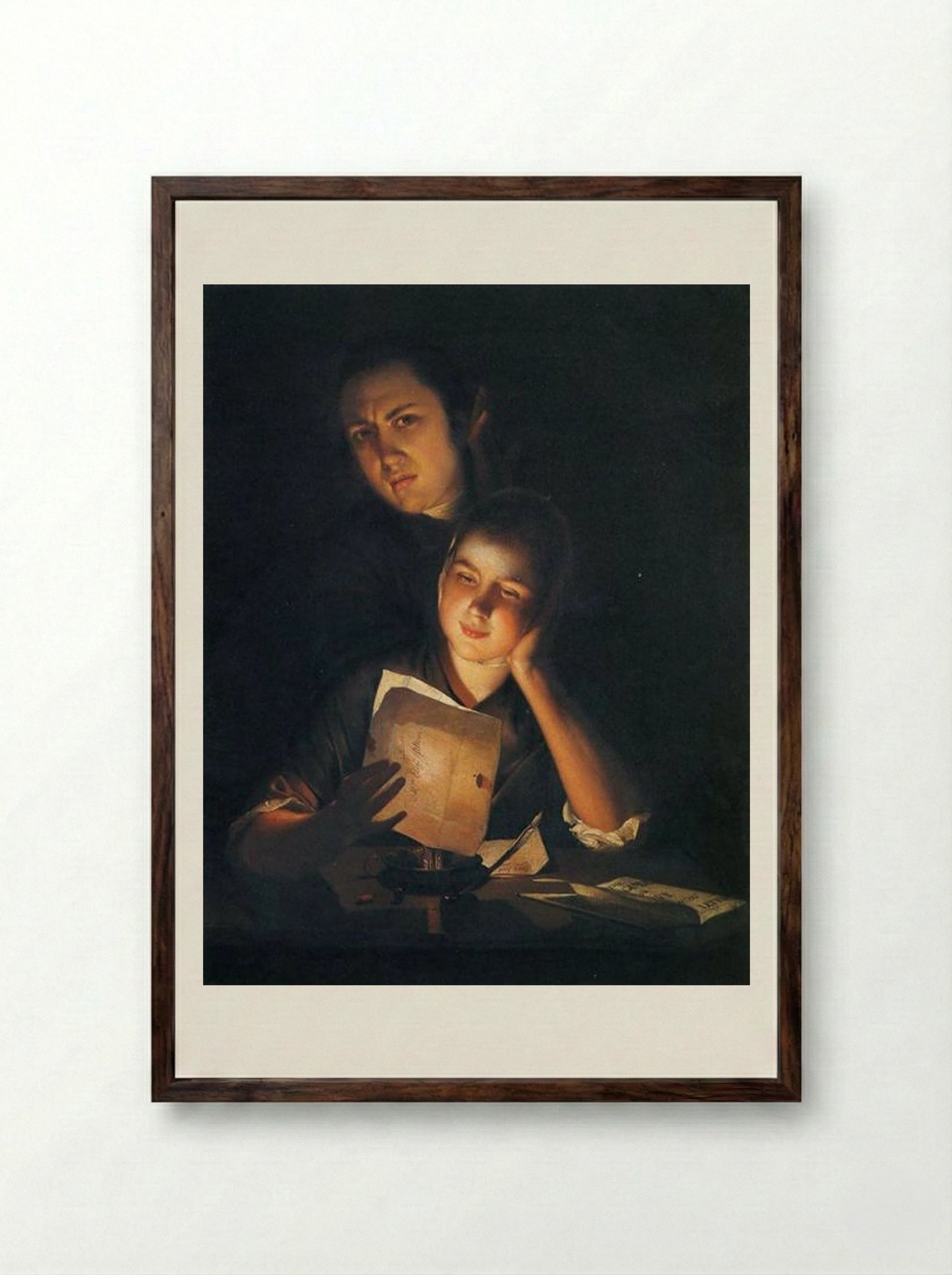 A Girl reading a letter by Candlelight, with a Young Man peering over her shoulder - Joseph Wright - Framed Print Dark Wood