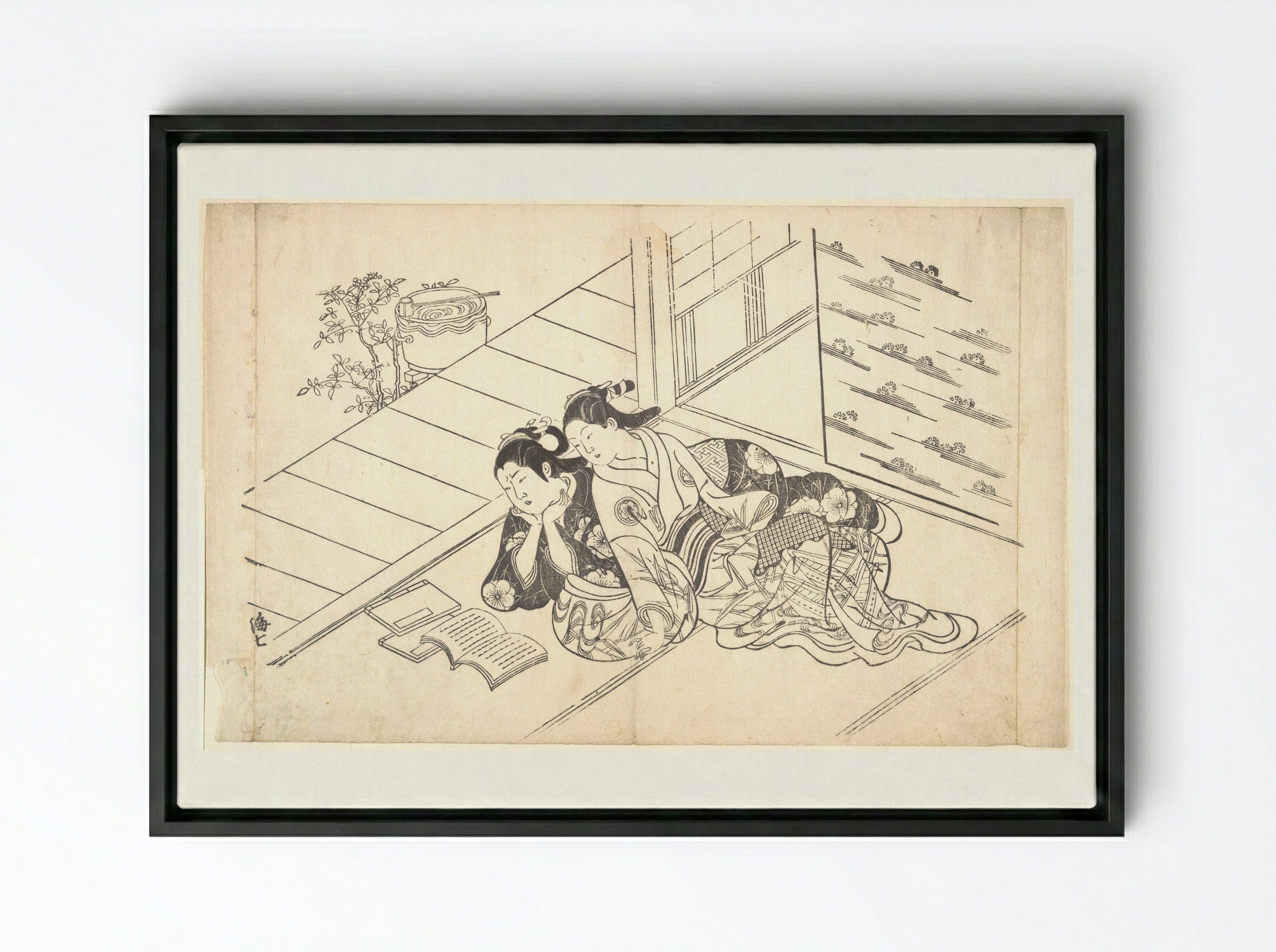 Two Women Reclining on the Floor of a Room and Reading a Book - Nishikawa Sukenobu - Framed Canvas Black
