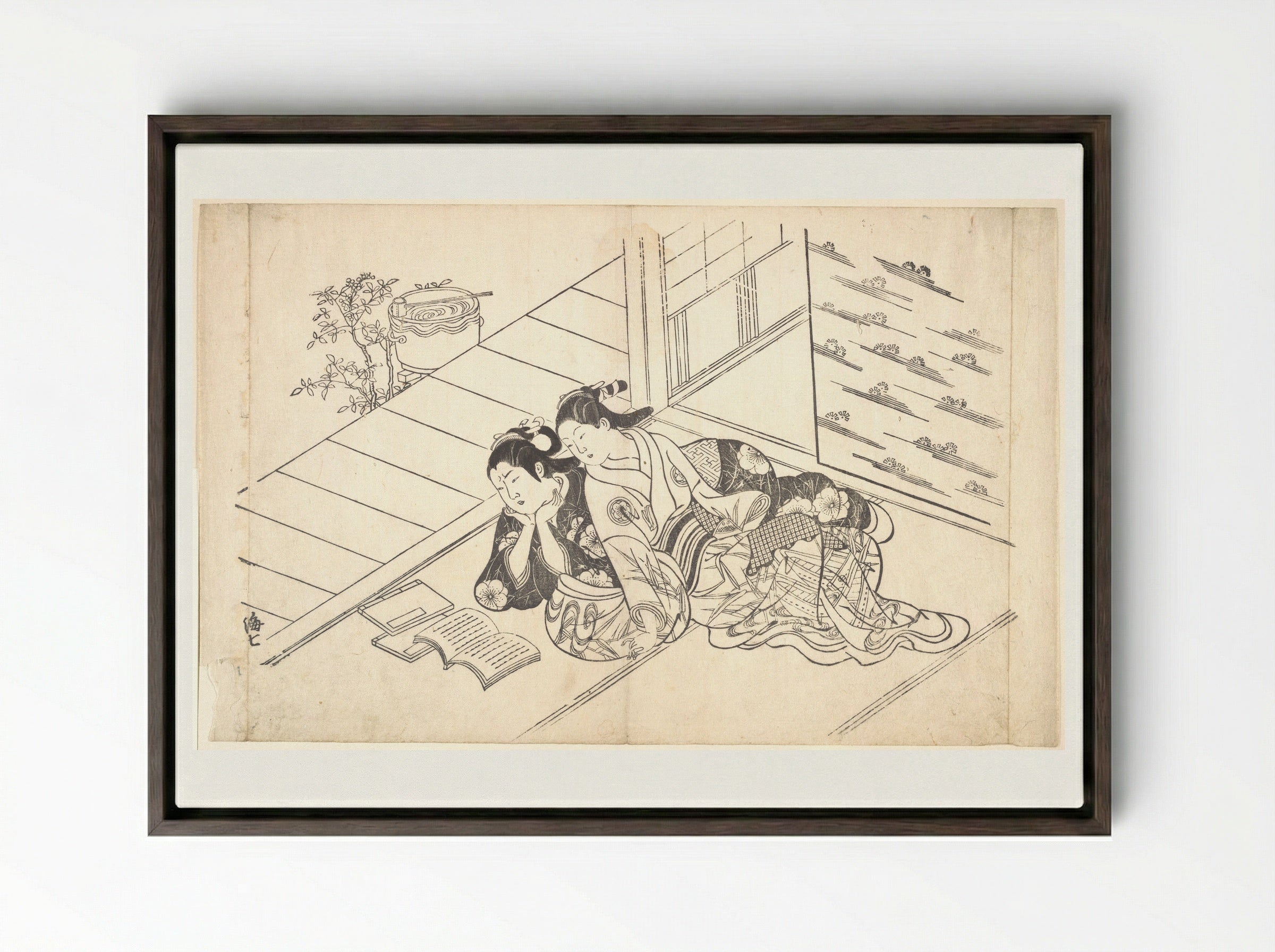 Two Women Reclining on the Floor of a Room and Reading a Book - Nishikawa Sukenobu - Framed Canvas Dark Wood