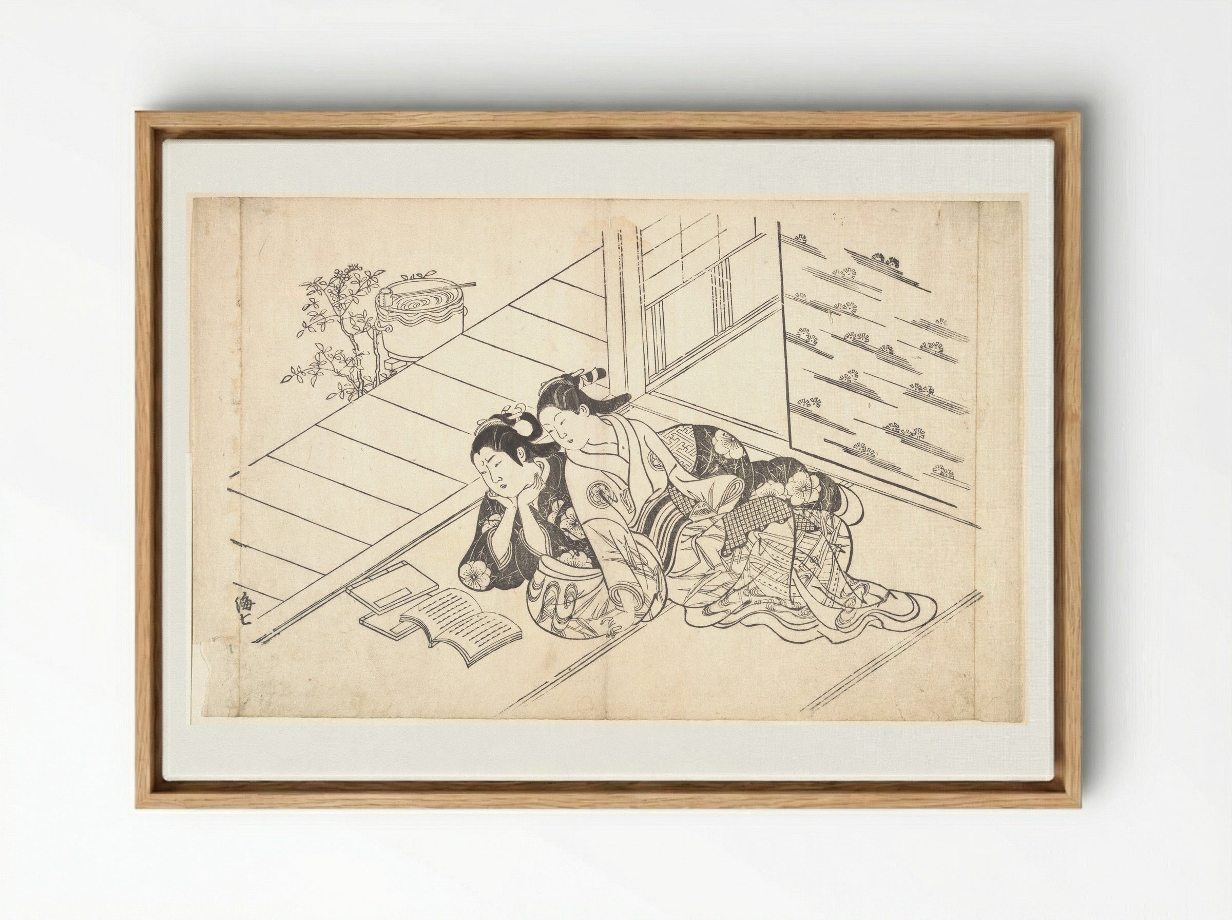 Two Women Reclining on the Floor of a Room and Reading a Book - Nishikawa Sukenobu - Framed Canvas Wood