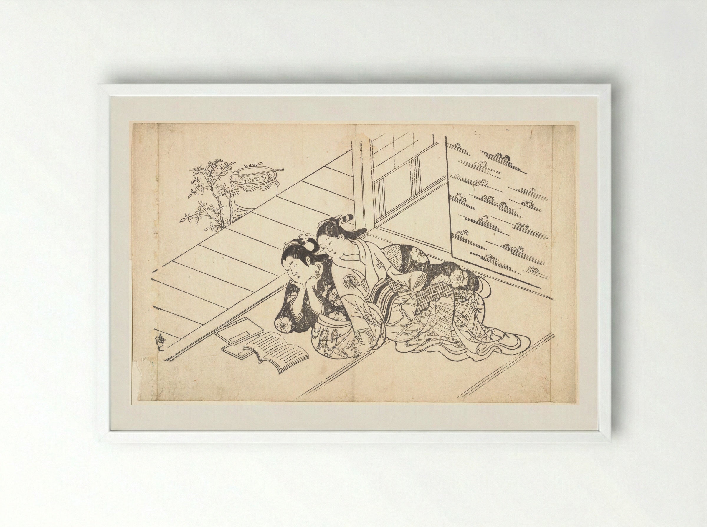 Two Women Reclining on the Floor of a Room and Reading a Book - Nishikawa Sukenobu - Framed Print White